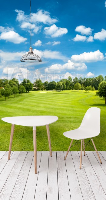 Picture of Green golf field and blue cloudy sky